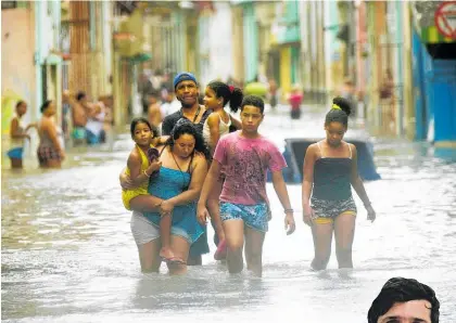  ??  ?? Hurricane Irma left Havana’s streets flooded in August. Osmeivy Ortega Pacheco (right) found himself in the midst of it just one day after returning home from Auckland.