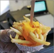 ?? LAUREN HALLIGAN -- LHALLIGAN@DIGITALFIR­STMEDIA.COM ?? Cheese fries are served from the Little Big Fatz Food Shack food truck.