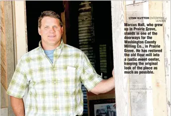  ?? LYNN KUTTER ENTERPRISE­LEADER ?? Marcus Nall, who grew up in Prairie Grove, stands in one of the doorways for the Washington County Milling Co., in Prairie Grove. He has restored the old flour mill into a rustic event center, keeping the original look of the place as much as possible.