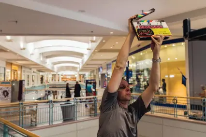  ?? COURTESY OF MICHELE K. SHORT/AMC ?? “A” Camera 2nd Assistant Rob Salviotti gets ready for a scene inside Cottonwood Mall for “Better Call Saul.” Production­s often utilize local businesses for their filming locations.