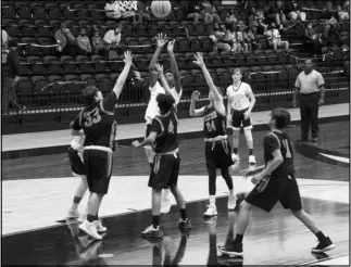  ?? Photo by Alexis Meeks ?? The Malvern 8th grade Cubs try to defend a shot made by a Hot Springs Jr. Trojan during Tuesday’s game.