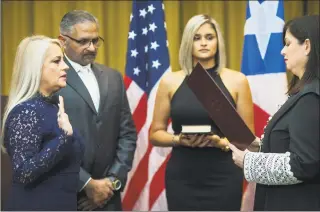  ?? Dennis M. Rivera Pichardo / Associated Press ?? Justice Secretary Wanda Vazquez is sworn in as governor of Puerto Rico by Supreme Court Justice Maite Oronoz, in San Juan, Puerto Rico, on Wednesday.