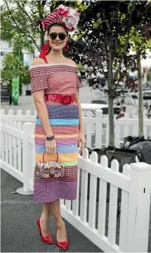  ?? GEORGE HEARD/STUFF ?? Jewellery designer Olivia Moor tried her luck in the Style Stakes event wearing a funky dress and hat, which were made by her mother.