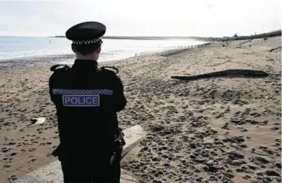  ?? Photograph: Kenny Elrick ?? ALERT: Police keep watch at the beach in Aberdeen after a device was found.