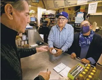  ?? Luis Sinco Los Angeles Times ?? RETIRED DODGERS star Steve Garvey, left, a Republican running for the Senate seat formerly held by the late Dianne Feinstein, visits a restaurant in Compton on Jan. 11.