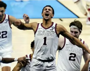  ?? Associated Press ?? Gonzaga hero Jalen Suggs celebrates with his teammates after the semifinal win.