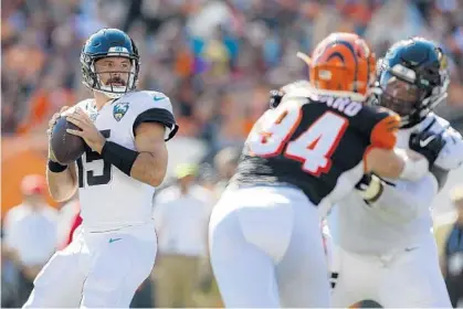  ?? GARY LANDERS/AP ?? Jaguars quarterbac­k Gardner Minshew looks for a receiver during his team’s victory over the Bengals (0-7) on Sunday in Cincinnati.