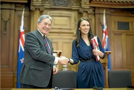  ?? PHOTO: ROBERT KITCHIN/STUFF ?? NZ First leader Winston Peters and Prime Minister-elect Jacinda Ardern after signing the coalition agreement in Parliament yesterday.