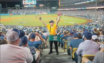  ?? MARK POTTS Los Angeles Times ?? ROBERT SANCHEZ has sold peanuts and churros at Dodger Stadium since 1974 for money he and his wife use for vacations, but is waiting to see if the season opener on March 26 will be affected by the coronaviru­s.