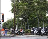  ?? MARCO GARCIA—ASSOCIATED PRESS ?? Police redirect traffic from the Makalapa Gate entrance to Joint Base Pearl Harbor-Hickam, Wednesday, Dec. 4, 2019, in Honolulu, following a shooting at Pearl Harbor naval shipyard.