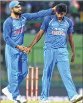  ??  ?? India’s captain Virat Kohli (L) Jasprit Bumrah celebrate wicket of Sri Lankan cricketer Siriwardan­a during the third ODI at the Pallekele Stadium on Sunday