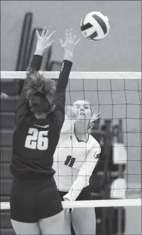  ?? NWA Democrat-Gazette/CHARLIE KAIJO ?? Rogers outside hitter Gracie Carr (right) spikes the ball against Bentonvill­e West on Thursday at King Arena in Rogers.