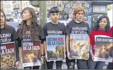  ?? ASSOCIATED PRESS 2012 ?? Animal rights protesters hold placards near a hospital in Madrid where Spanish King Juan Carlos was treated for an injury suffered while elephant hunting in Botswana. Carlos was criticized for the trip.