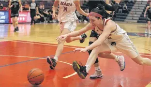  ?? JASON MALLOY ?? Acadia Axewomen wing Sophie Atkinson, right, dives for a loose ball after winning the race with Saint Mary’s Huskies guard Alaina McMillan during the Feb. 27 Atlantic University Sport basketball game in Wolfville. Atkinson, a second-year player from Yarmouth, had four rebounds and two assists in the game. She had 12 points and five boards in the Feb. 25 win at Saint Mary’s.