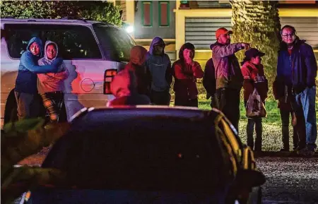  ?? Photos by Gabrielle Lurie/The Chronicle ?? Above: People embrace at the scene of a deadly shooting off of Highway 92 on Monday in Half Moon Bay. Seven people were killed and another was injured.