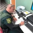  ?? BEN DICKMANN VIA AP ?? A deputy at the Broward County sheriff's office in Ft. Lauderdale, Fla., processes paperwork Feb. 16 to take possession of and destroy Dickmann's AR-style firearm.