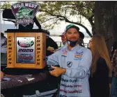  ?? PHOTO BY BOB MINENNA ?? Pro champion John Pearl poses with his championsh­ip trophy and new bass boat.