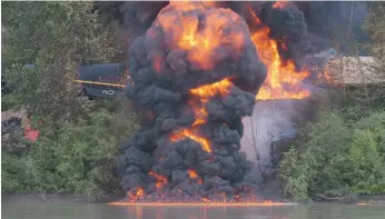  ?? CITIZEN FILE PHOTO ?? A CN Rail train car burns after two trains collided along the banks of the Fraser River in Prince George on Aug. 4, 2007. The District of Vanderhoof is calling on Transport Canada to order railways to provide informatio­n on hazardous goods being...