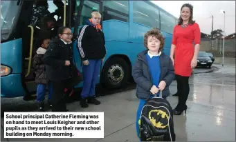  ??  ?? School principal Catherine Fleming was on hand to meet Louis Keigher and other pupils as they arrived to their new school building on Monday morning.