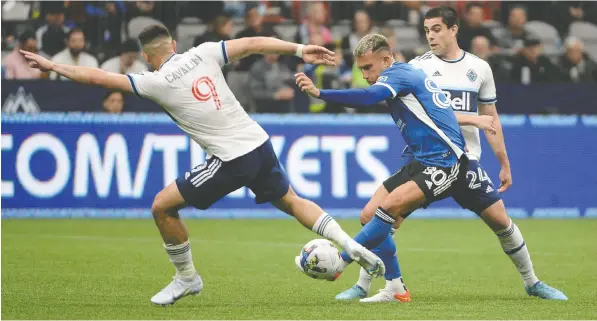  ?? ANNE-MARIE SORVIN/USA TODAY SPORTS ?? Whitecaps forward Lucas Cavallini, left, reaches for the ball against San Jose's Francisco Calvo during Saturday night's 3-3 tie at B.C. Place. Cavallini scored one of the Caps' goals and almost headed in a last-minute winner.