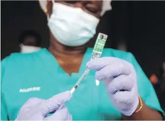  ?? SUNDAY ALAMBA, THE ASSOCIATED PRESS ?? A nurse prepares one of Nigeria’s first coronaviru­s vaccinatio­ns, using AstraZenec­a vaccine manufactur­ed by the Serum Institute of India and provided through the global COVAX initiative, at the Yaba Mainland hospital in Lagos, Nigeria.