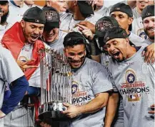  ?? Brett Coomer / Houston Chronicle ?? Astros second baseman Jose Altuve holds the World Series trophy as the team celebrates it victory over the Dodgers.