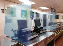 ?? Billy Calzada / Staff photograph­er ?? Plexiglass panes have been placed in the cafeteria cashiers’ area as a measure against the transmissi­on of the coronaviru­s at Forester Elementary.