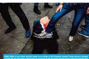  ??  ?? HONG KONG: A pro-China activist steps on an effigy of US President Donald Trump during a protest outside the US consulate in Hong Kong in response to US President Donald Trump saying he would strip several of Hong Kong’s special privileges with the United States and bar some Chinese students from US universiti­es in anger over Beijing’s bid to exert control in the financial hub.— AFP