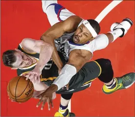  ?? MARK J. TERRILL / AP ?? Jazz forward Gordon Hayward (left) has his shot defended by retiring Clippers forward Paul Pierce, whose 19-year NBA career came to an end Sunday.