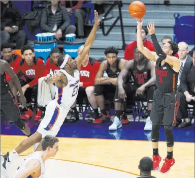  ?? Darin Oswald The Associated Press ?? UNLV’S Noah Robotham launches a 3-pointer in the second half as Boise State’s RJ Williams reaches out to defend.