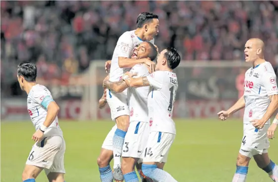  ??  ?? Bangkok United’s Everton Concalves, No.3, celebrates with teammates after scoring his team’s first goal against Port at PAT stadium.