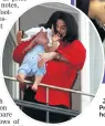  ?? Picture: GETTY IMAGES ?? HIGH AS A KITE: Jackson dangles his son Prince Michael II over a hotel balcony in 2002.