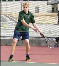  ?? ?? Isaac Read returns a backhand shot in no.1 doubles against South. Read teamed up with Calvin Hibbard to win his match, 8-5.