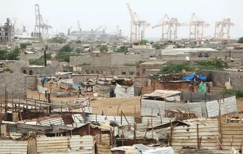  ?? Reuters ?? Hodeida port’s cranes tower over a nearby shantytown. The port is a lifeline for millions of Yemenis.