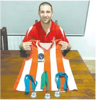  ??  ?? Left - Chris Kyriacou with his prized triple premiershi­p guernsey, alongside his medallions.