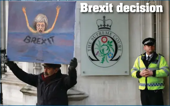  ?? Photograph: AP ?? Painter Kaya Mar shows his latest painting of British Prime Minister Theresa May in front of the Supreme Court in London, yesterday