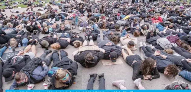  ??  ?? OHIO: Protesters hold a die-in as they gather peacefully to protest the death of George Floyd at the State Capital building in downtown Columbus, Ohio. — AFP