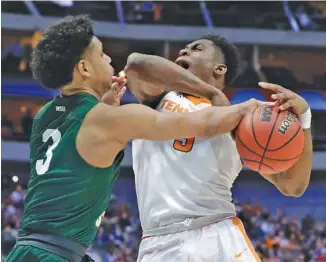  ?? THE ASSOCIATED PRESS ?? Tennessee forward Admiral Schofield tries to muscle past Wright State’s Mark Hughes (3) during the Vols’ first-round win Thursday in the NCAA tournament. Schofield had 15 points and 12 rebounds in the game.