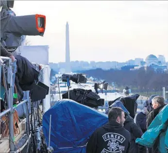  ?? Marcus Yam Los Angeles Times ?? CNN, Fox News and MSNBC have seen a surprising surge in viewership this month as they report on the unpredicta­ble saga of Trump. Above, TV news crews prepare to cover the presidenti­al inaugurati­on.