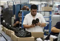  ?? MARIO ARMAS/ASSOCIATED PRESS ?? People work in a shoe maquilador­a, or factory, in Leon, Mexico, earlier this month.