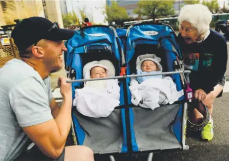  ?? Helen H. Richardson, The Denver Post ?? Gloria Siekmeier, 84, chats with her grandson-in-law, Ben Feijoo, as they admire her great-grandchild­ren, and Feijoo’s kids, Eliana, left, and her twin brother Gabriel before the start of the 35th annual Cherry Creek Sneak on Sunday. Siekmeier has run...