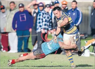  ??  ?? Text book: Mt Albert Lions’ Johnny Aranga is brought down in Jacob Aki’s perfect tackle.