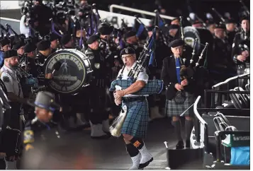  ?? Brian A. Pounds / Hearst Connecticu­t Media ?? Pipe and drum corps from law enforcemen­t agencies march into the Xfinity Theatre in Hartford on Thursday before playing “Amazing Grace” during the funeral for State Police Sgt. Brian Mohl.