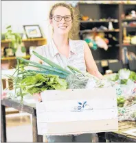  ?? MARGARET JOURDAN STUDIO ?? Chloe Donatelli, a volunteer with the Pan Cape Breton Food Hub Co-op, is seen carrying a crate this season. The food hub has had $120,000 in sales for 2017 and has expanded to Inverness.