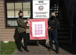  ?? SUBMITTED ?? Annie Dunn, left, program coordinato­r at WIC, receives the 1,000th quilt made by Humboldt Project Linus. It’s being presented by Nancy Corral, the local chapter coordinato­r.