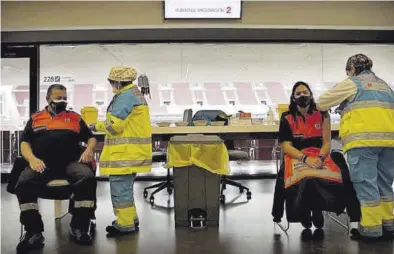  ?? JOSÉ LUIS ROCA ?? Dos trabajador­es esenciales reciben la vacuna en el Wanda Metropolit­ano de Madrid, ayer viernes.