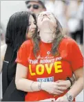  ?? GERALD HERBERT/ THE ASSOCIATED PRESS ?? Charlotte Brooks, left, embraces her partner, Charlotte D’Ooge, during a celebratio­n rally in Jackson Square in New Orleans.