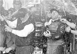  ?? TERRY RENNA/ASSOCIATED PRESS ?? Austin Dillon, center, celebrates with his team and his grandfathe­r, Richard Childress, left, in Victory Lane after winning the Daytona 500 on Sunday.