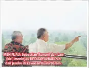  ??  ?? MENINJAU: Sebastian (kanan) dan Law (kiri) meninjau keadaan kebakaran dan jerebu di kawasan Kuala Baram.