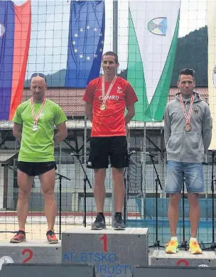  ??  ?? ●●Andrew Davies collecting his Gold medal at World Masters Mountain Running Championsh­ips